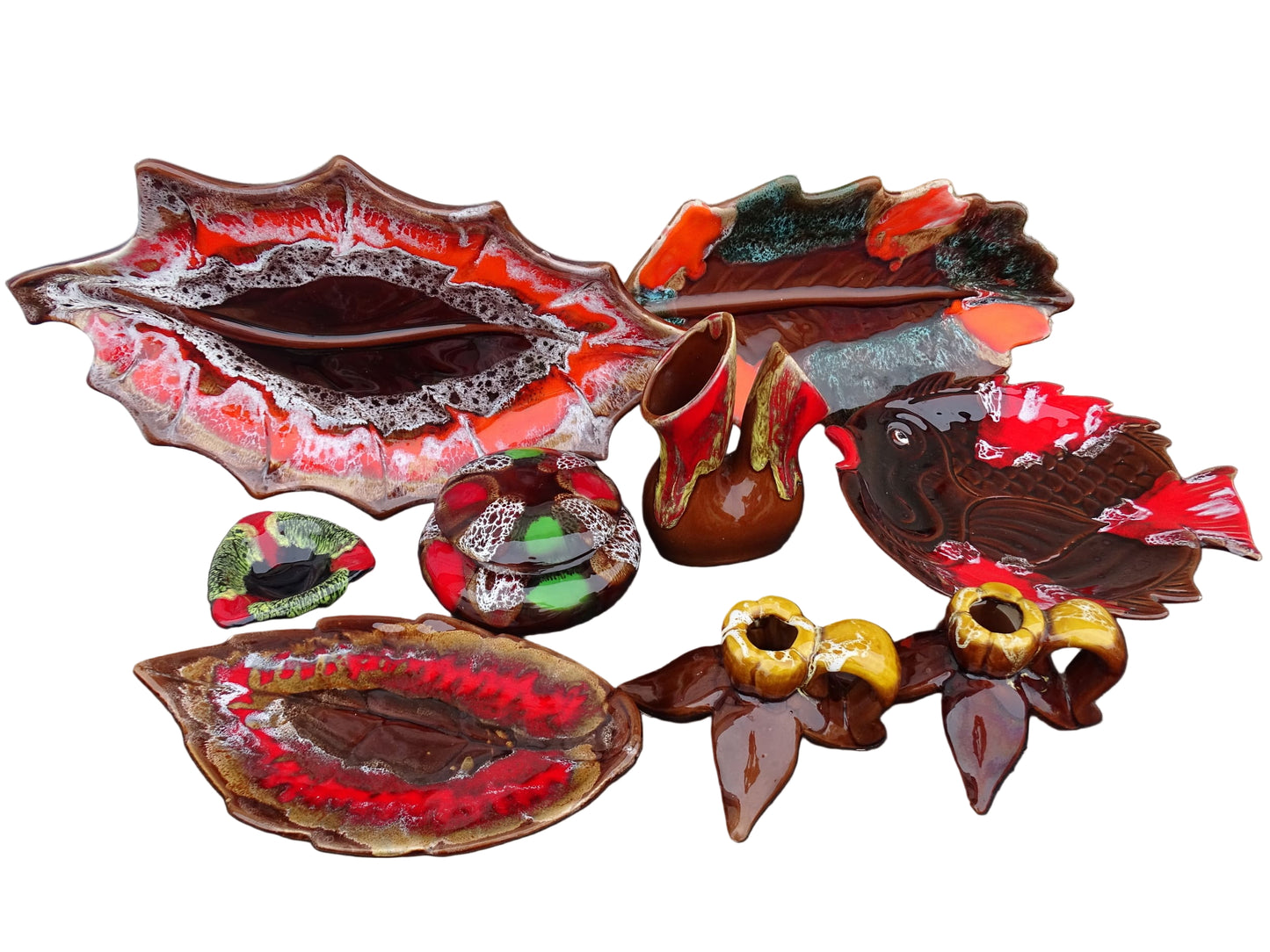 A collection of vintage French Vallauris pottery in bright colours. Including a vase, leaf bowls and candle holders. 