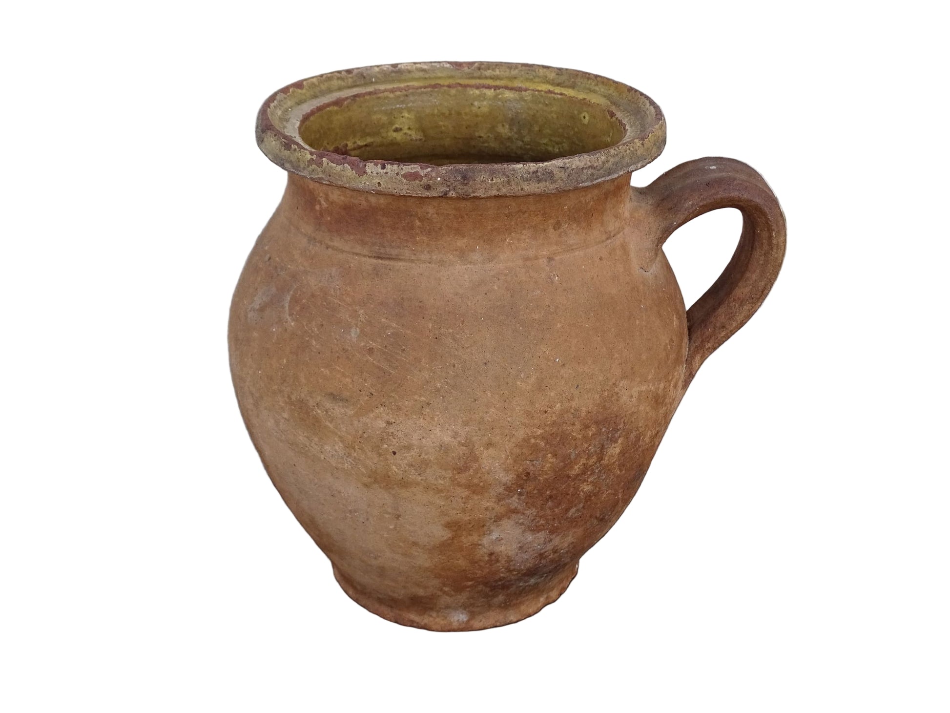 French antique terracotta jug with yellow glaze interior, rustic earthenware pitcher. 