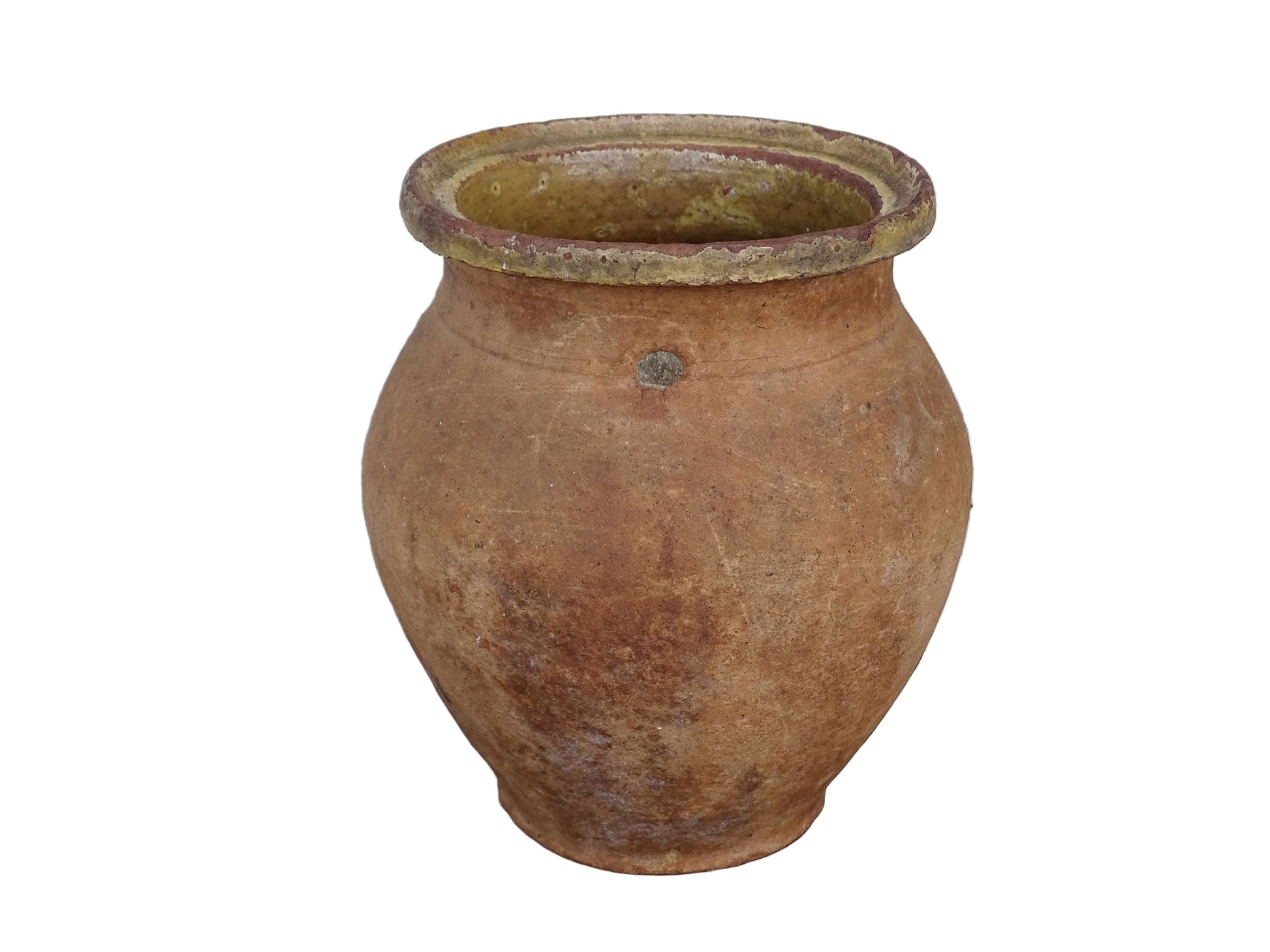 French antique terracotta jug with yellow glaze interior, rustic earthenware pitcher. 