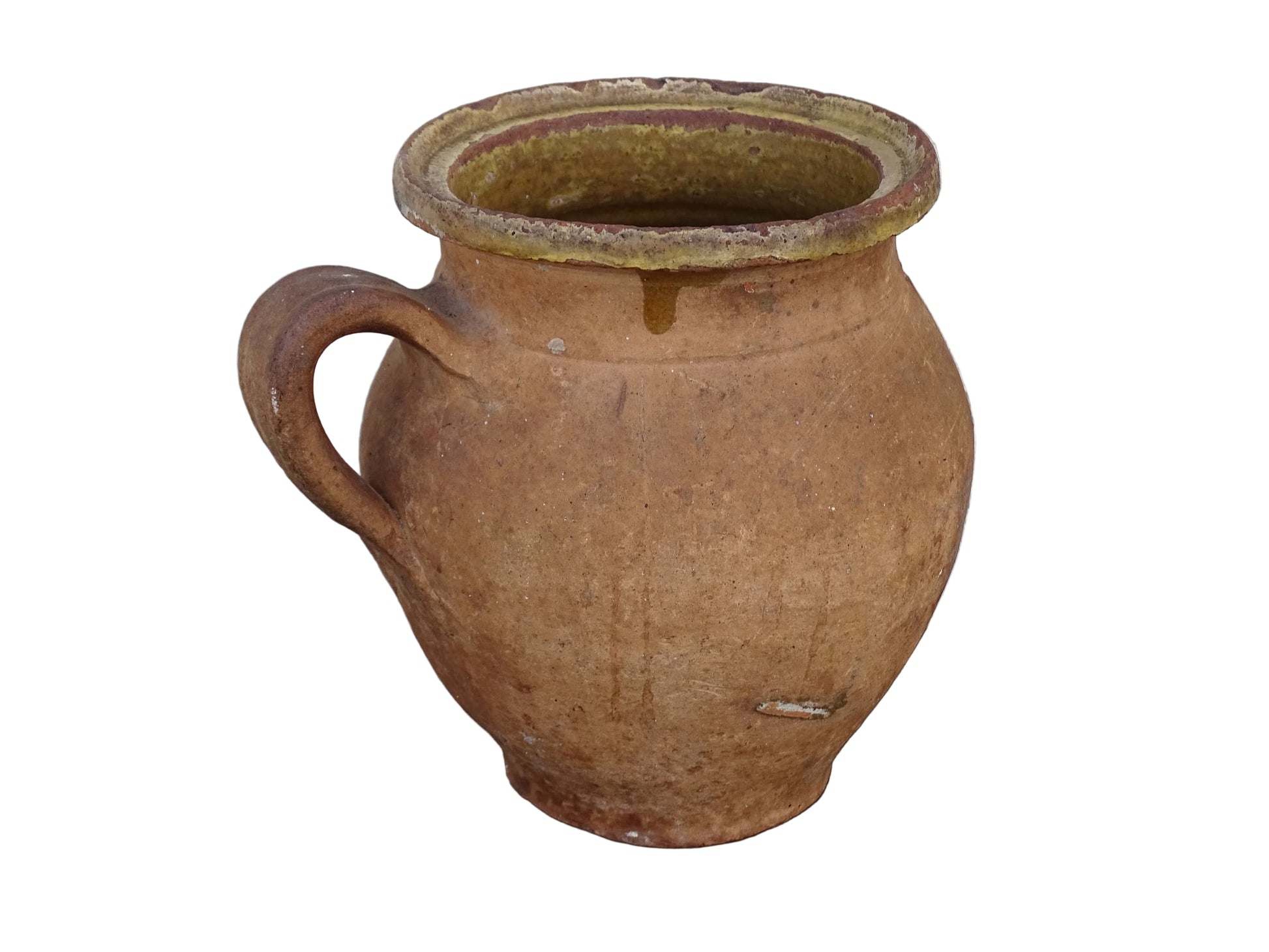French antique terracotta jug with yellow glaze interior, rustic earthenware pitcher. 