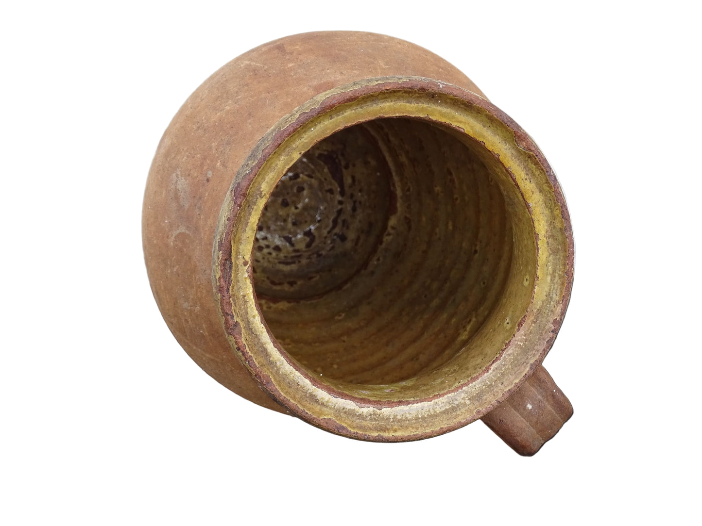 French antique terracotta jug with yellow glaze interior, rustic earthenware pitcher. 