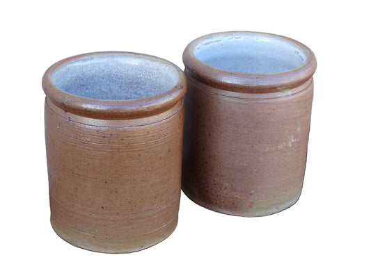 Rustic pair of French vintage stoneware pots with a brown, salt glaze. Old pottery jars with a ribbed texture.