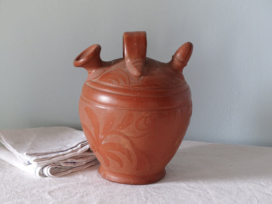 Vintage ceramic jug or gargoulette in red with floral pattern