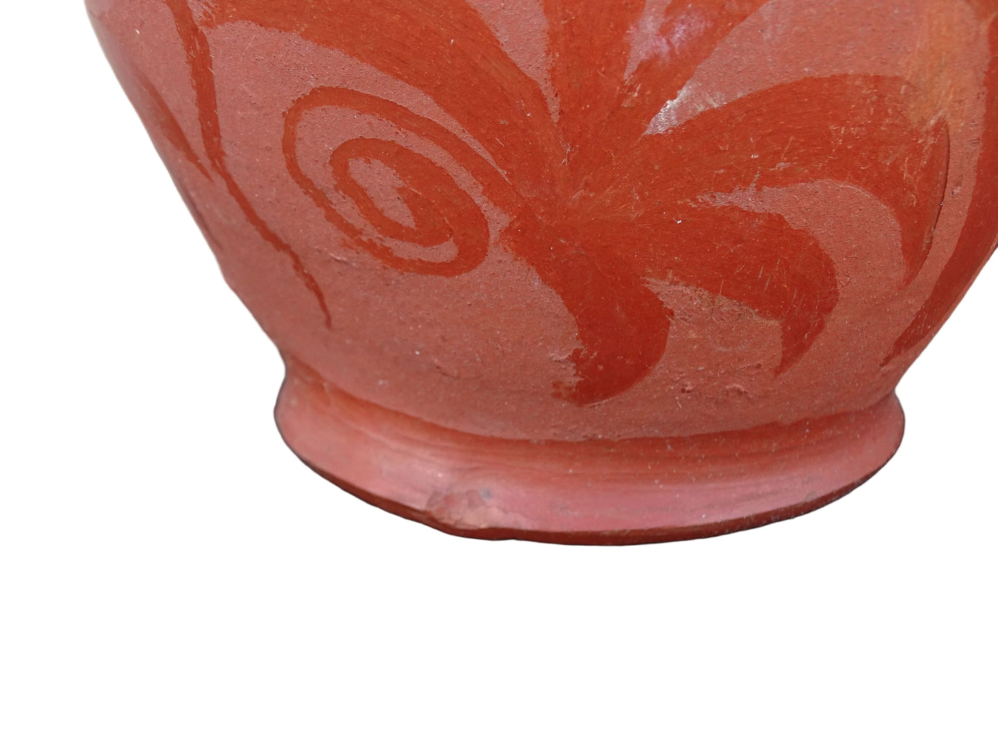 French vintage ceramic gargoulette in a deep red colour with floral detailing. The body of this terracotta jug is a rounded shape with a handle to the top and two spouts.
