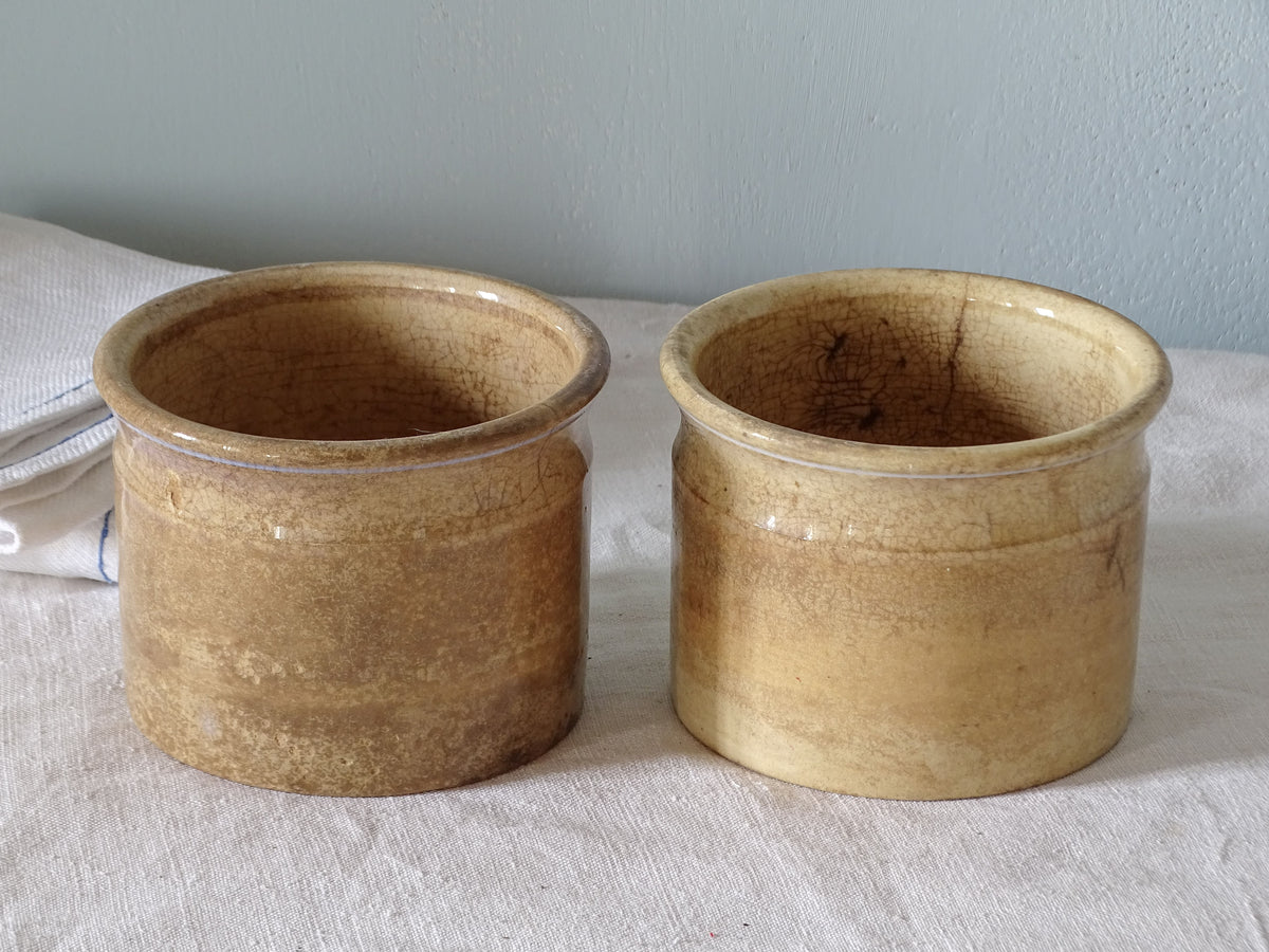 Pair of French antique ironstone confiture pots with worn glaze
