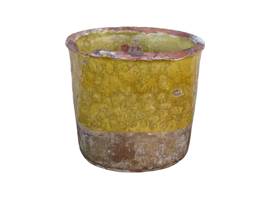French antique yellow confit pot with patina. Aged earthenware pot with glaze.