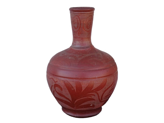 French vintage pottery vase in a deep red colour with floral detailing. The body of this terracotta vessel is bulbous in shape.
