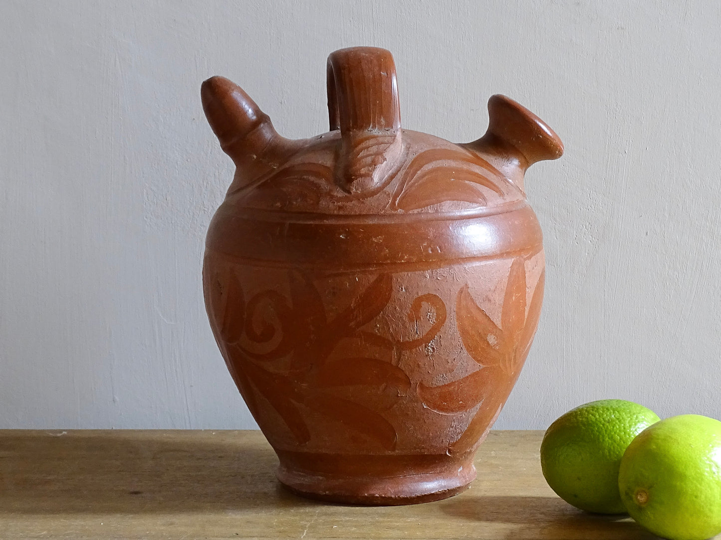 French vintage pottery gargoulette in red with floral detailing. Ceramic jug with handle and two spouts. 