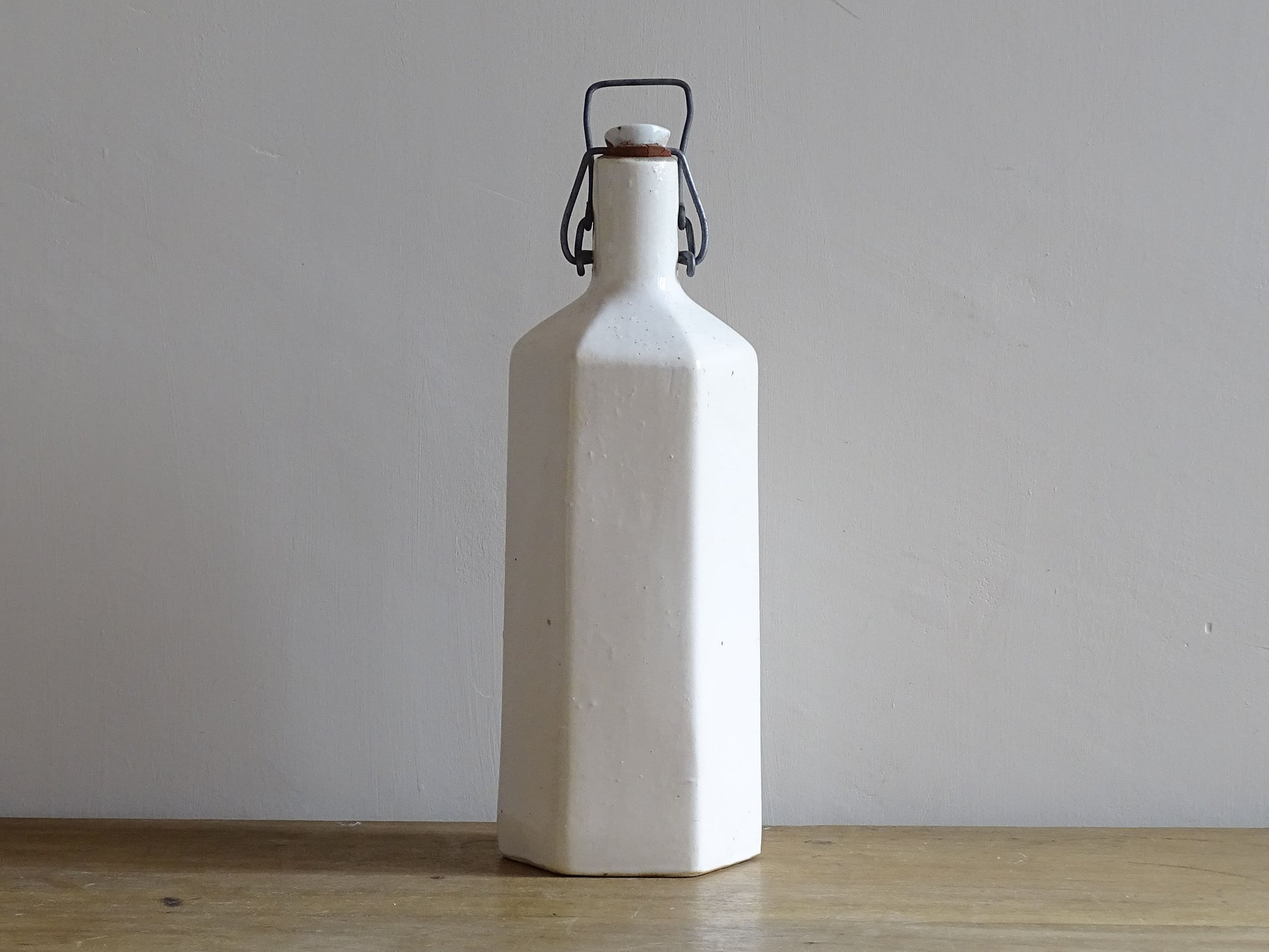 Vintage stoneware bottle with a white glaze.