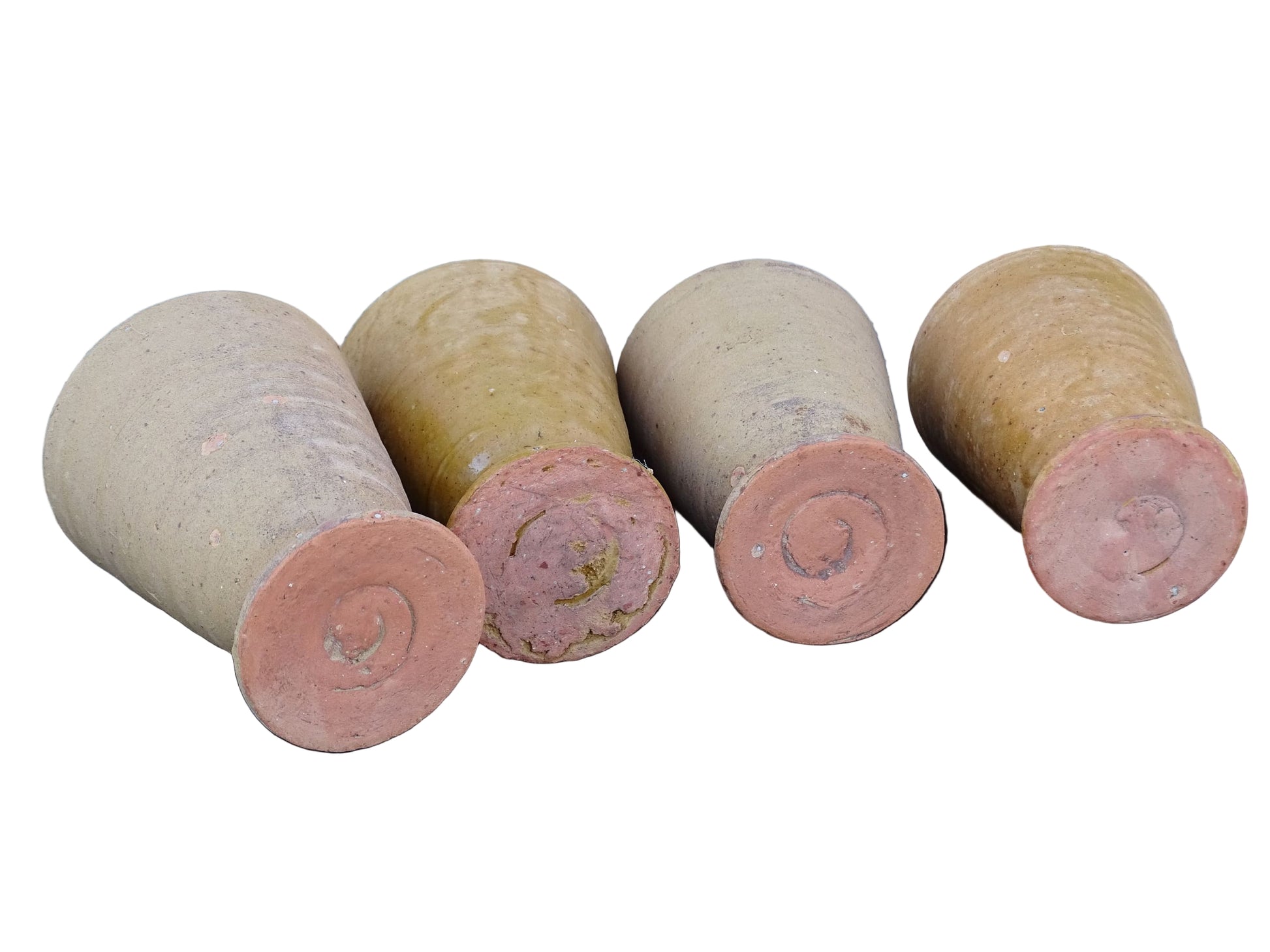 Set of four French vintage terracotta goblets. Of the four pottery cups, one has a beautiful yellow glaze, another is partially glazed and the other two are unglazed.