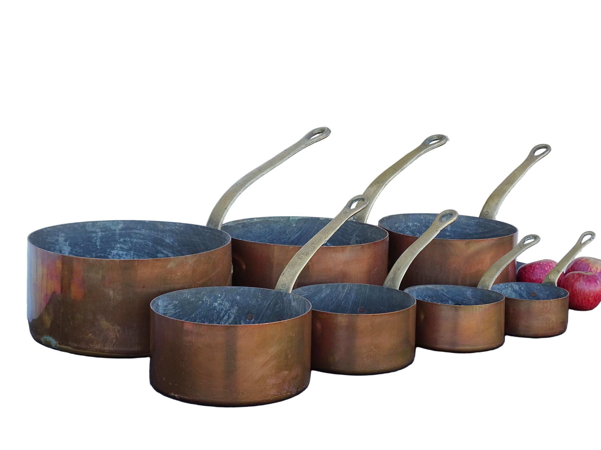 Set of seven French antique copper pans with brass handles. Tinned copper saucepans.