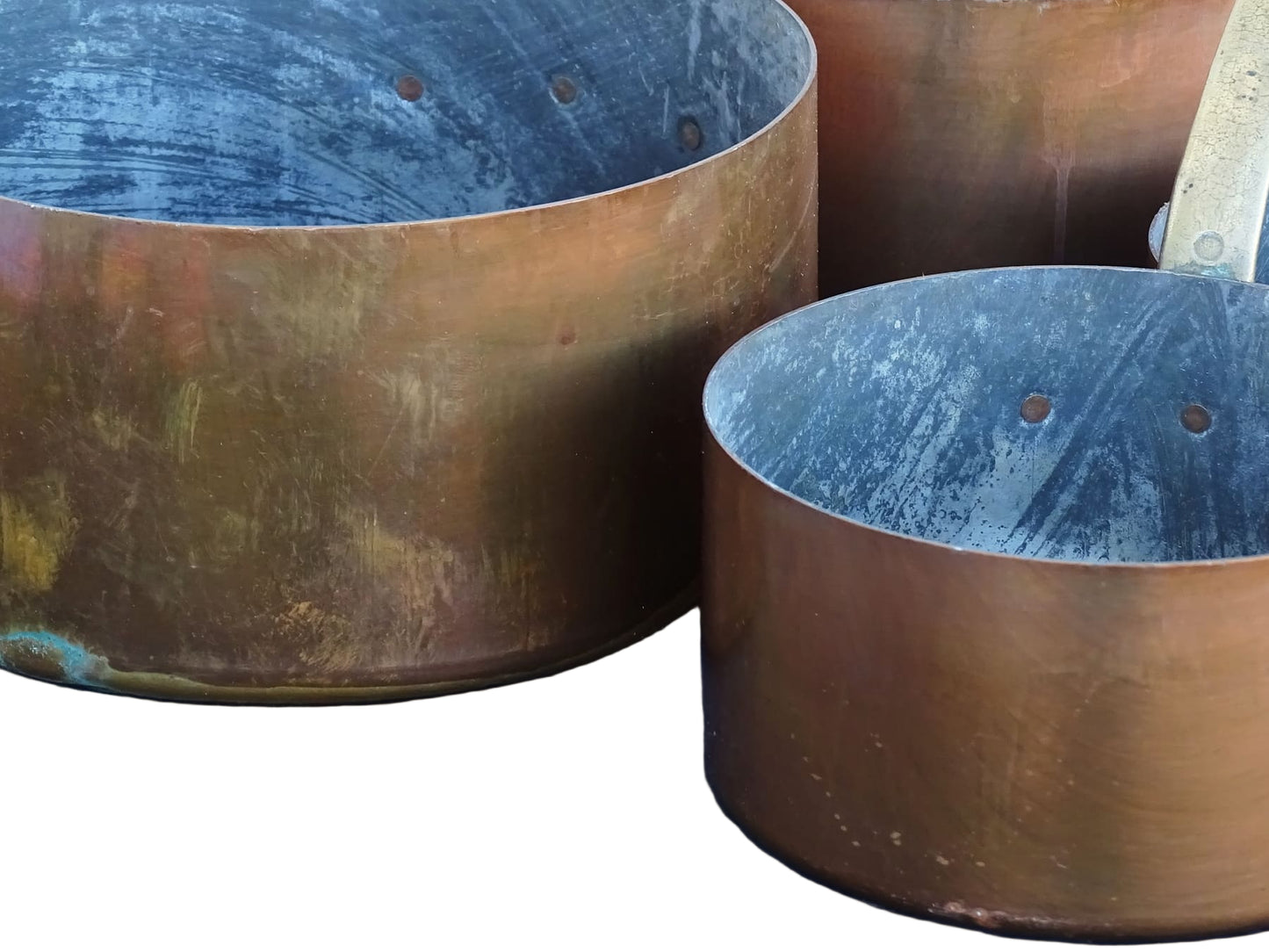 Set of seven French antique copper pans with brass handles. Tinned copper saucepans.