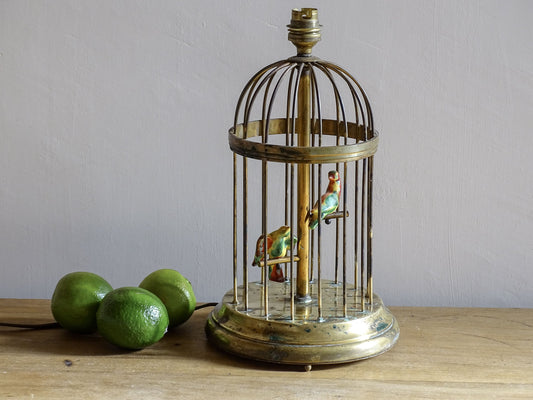 A French vintage brass birdcage lamp base with pretty little ceramic birds perched inside. This sweet lamp base with it's domed form and stepped base is highly distinctive. It dates from circa 1950.