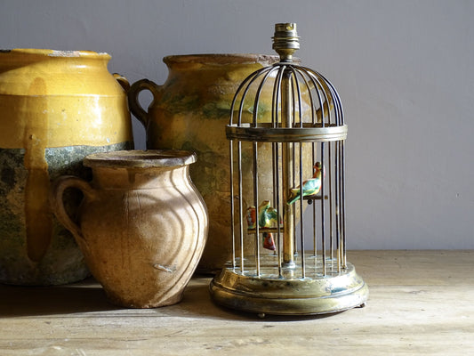 A French vintage brass birdcage lamp base with pretty little ceramic birds perched inside. This sweet lamp base with it's domed form and stepped base is highly distinctive. It dates from circa 1950.