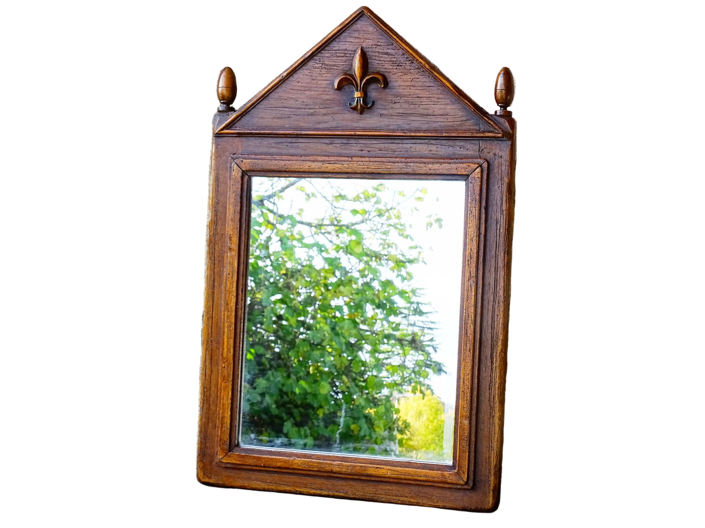 French antique wooden mirror topped with a triangular pediment decorated with a fleur de lis and two turned finial