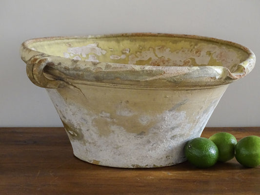 French antique tian bowl with a yellow glazed interior. Old terracotta confit bowl from the 19th century.
