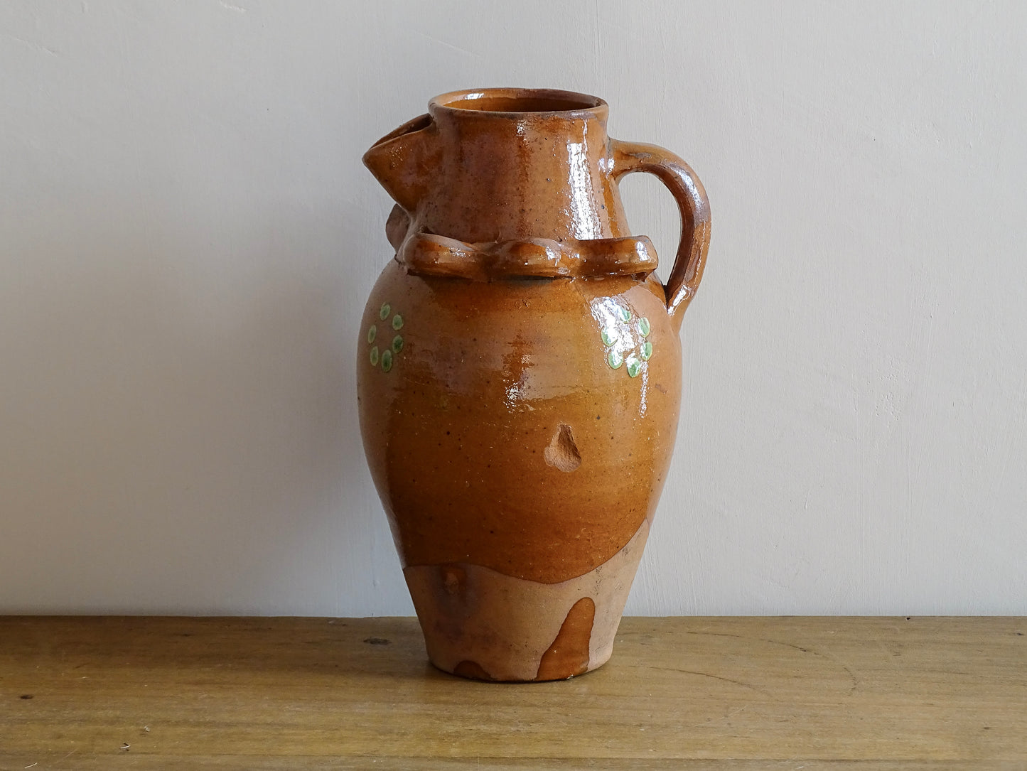 French antique terracotta pitcher from Savoie with orange glaze and yellow dots. Savoyard pottery jug with applied detailing. 