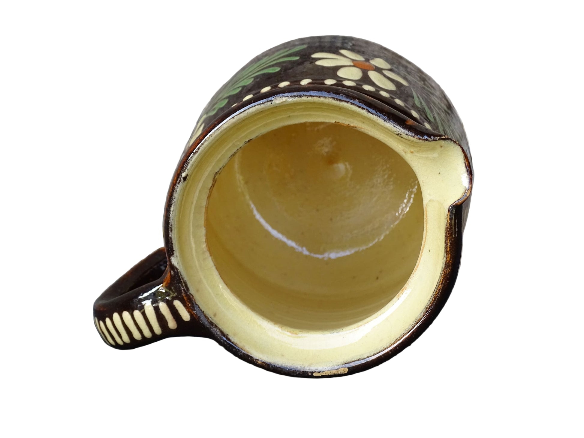 French vintage ceramic pitcher from Alsace. Pottery jug with brown glaze and hand painted with flowers, leaves and dots.