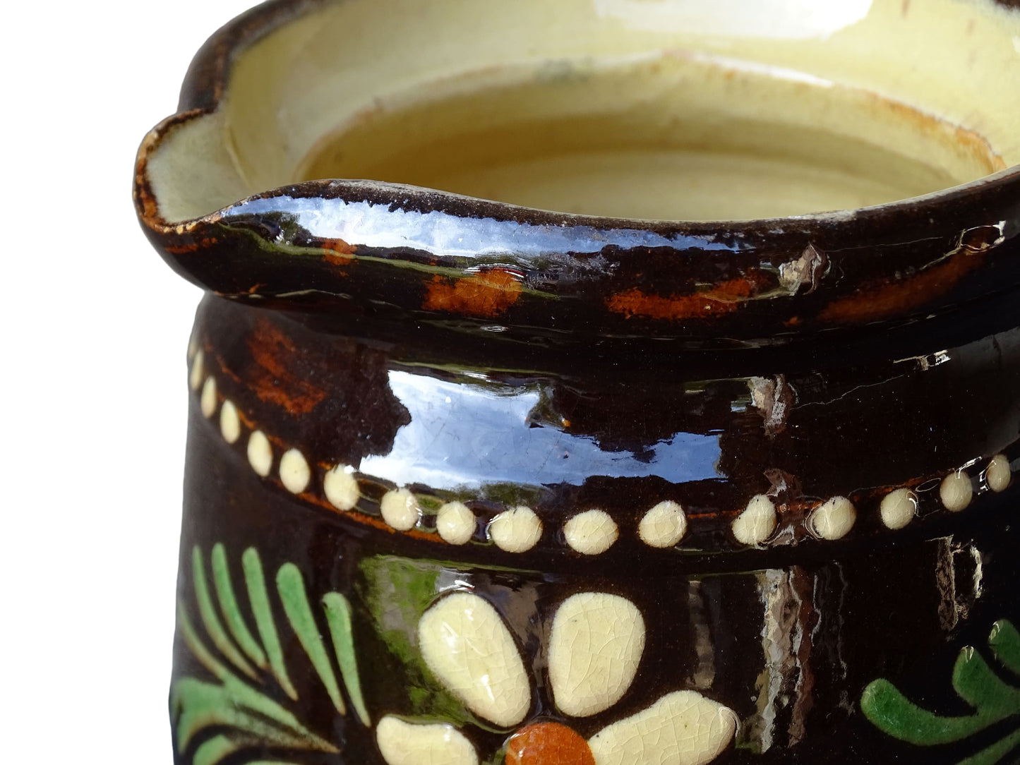 French vintage ceramic pitcher from Alsace. Pottery jug with brown glaze and hand painted with flowers, leaves and dots.