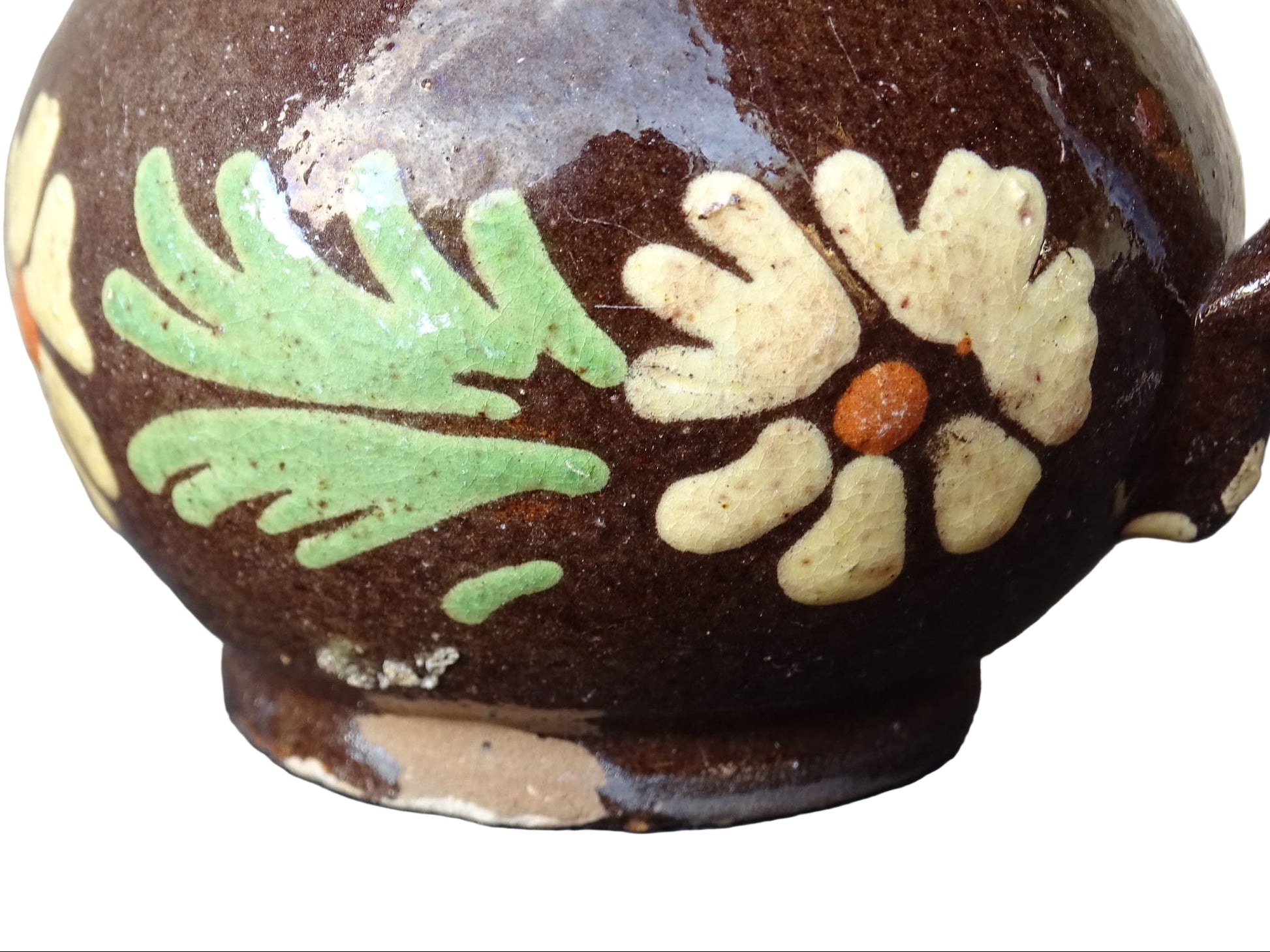 Small French vintage pottery pitcher from Alsace. Ceramic jug with a brown glaze and yellow glazed stripe around the top. It is hand painted with white flowers, green leaves and dots.