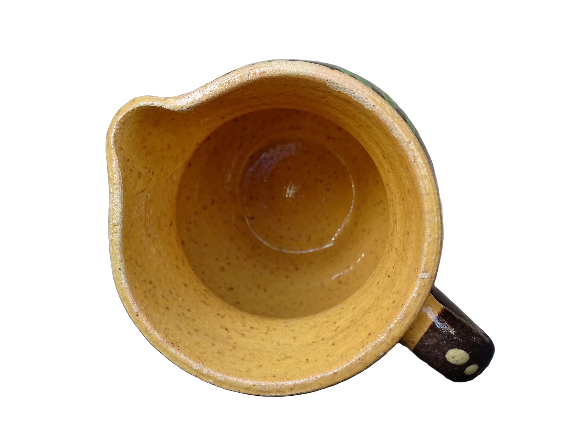 Small French vintage pottery pitcher from Alsace. Ceramic jug with a brown glaze and yellow glazed stripe around the top. It is hand painted with white flowers, green leaves and dots.