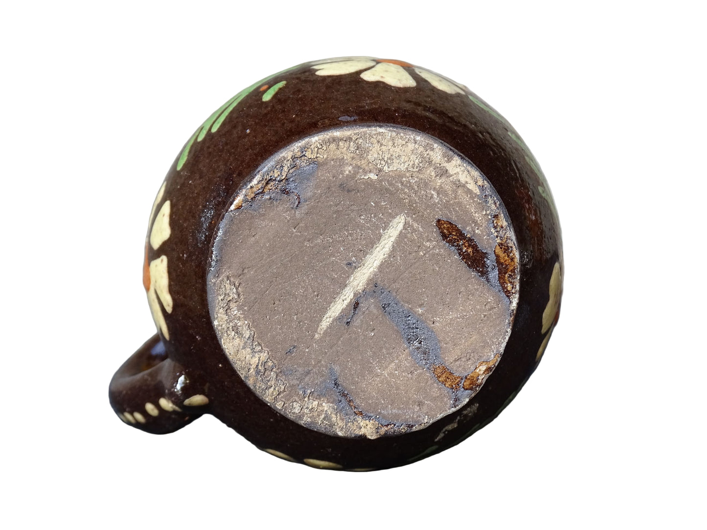 Small French vintage pottery pitcher from Alsace. Ceramic jug with a brown glaze and yellow glazed stripe around the top. It is hand painted with white flowers, green leaves and dots.