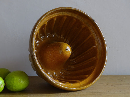 French vintage ceramic mould with a yellow glaze interior and unglazed exterior.