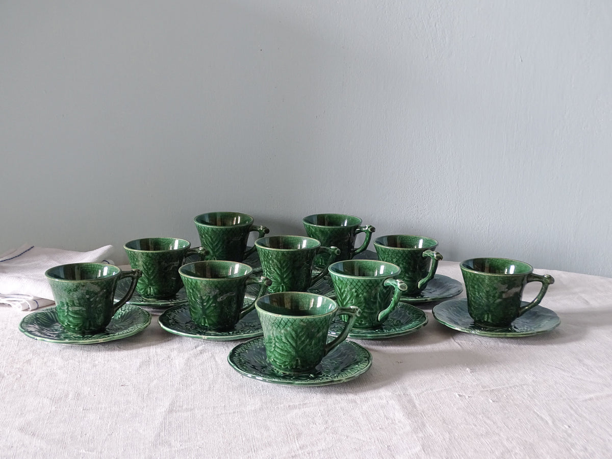 Set of 10 French vintage ceramic coffee cups in green by Gien, pictured with antique linen