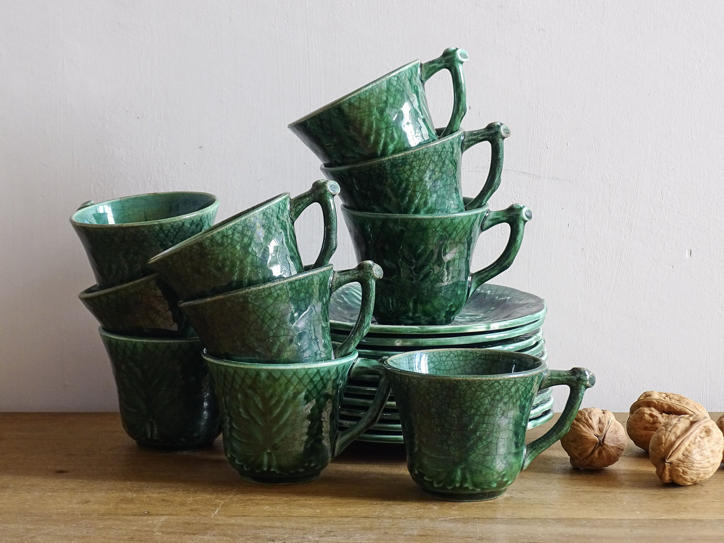 Set of 10 vintage coffee cups by Gien in the Primefleur design with leaf patterns. Green glazed ceramic cups and saucers. Barbotine or majolica cups. 