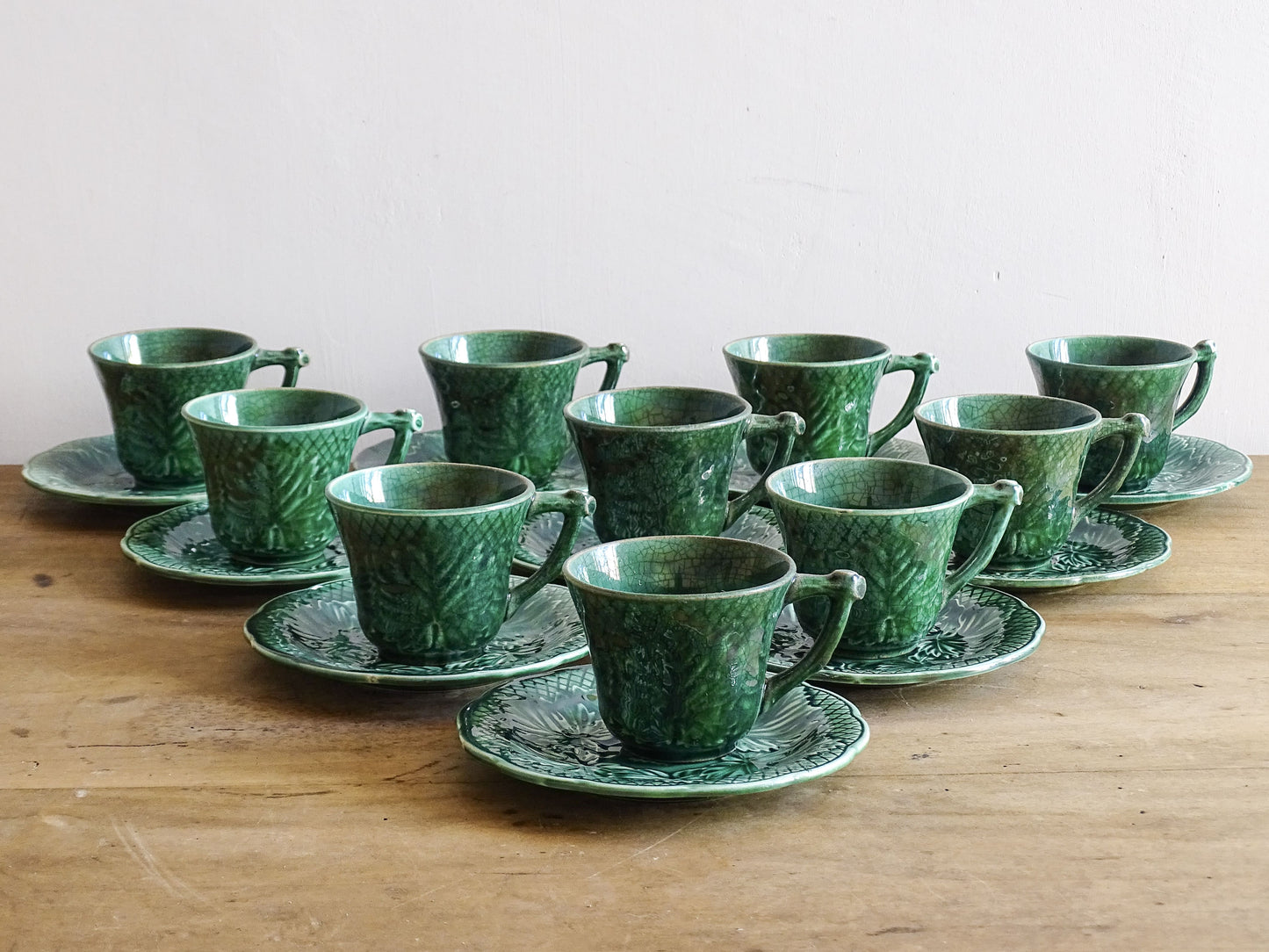Set of 10 vintage coffee cups by Gien in the Primefleur design with leaf patterns. Green glazed ceramic cups and saucers. Barbotine or majolica cups. 