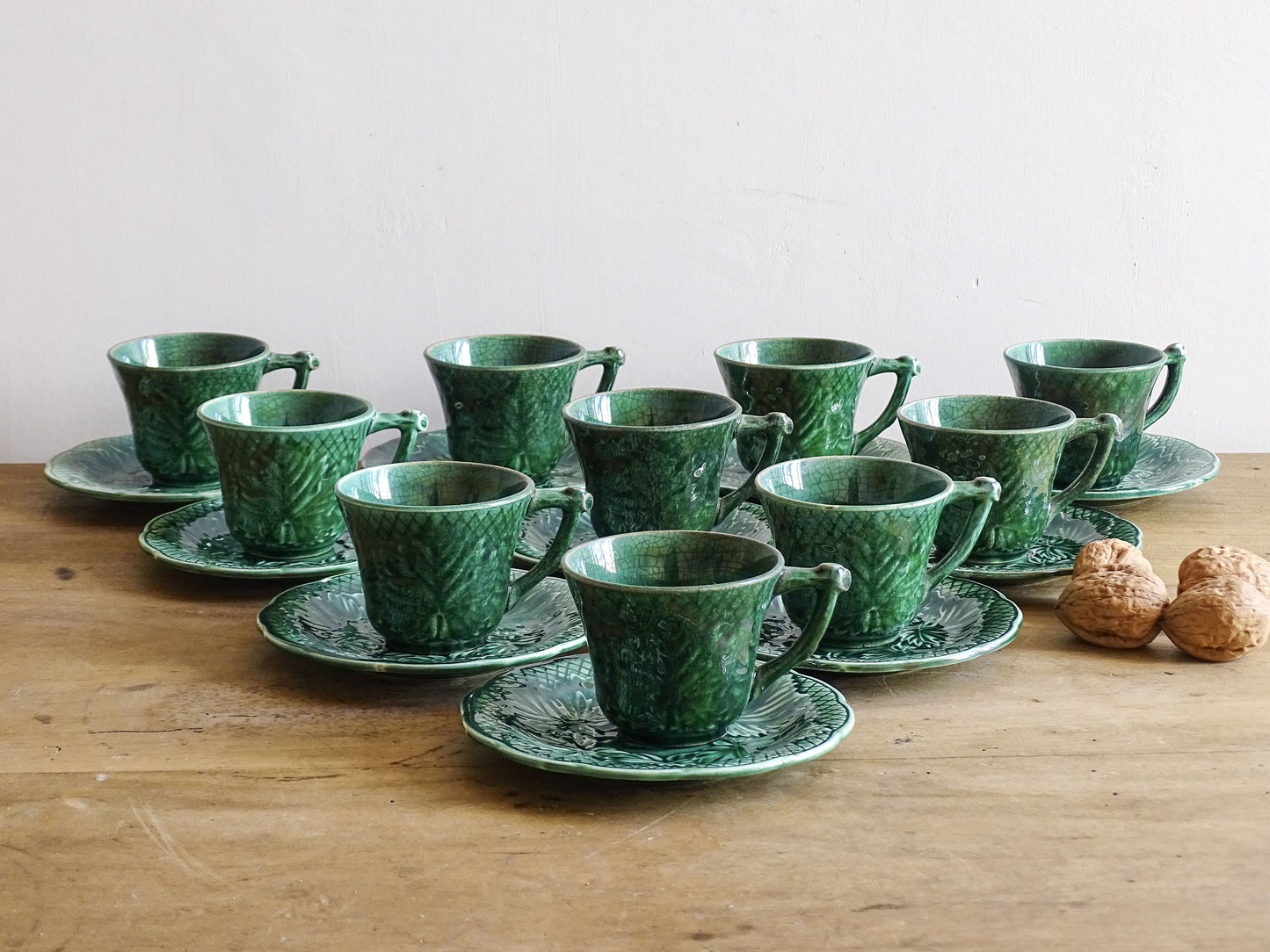 Set of 10 vintage coffee cups by Gien in the Primefleur design with leaf patterns. Green glazed ceramic cups and saucers. Barbotine or majolica cups. 