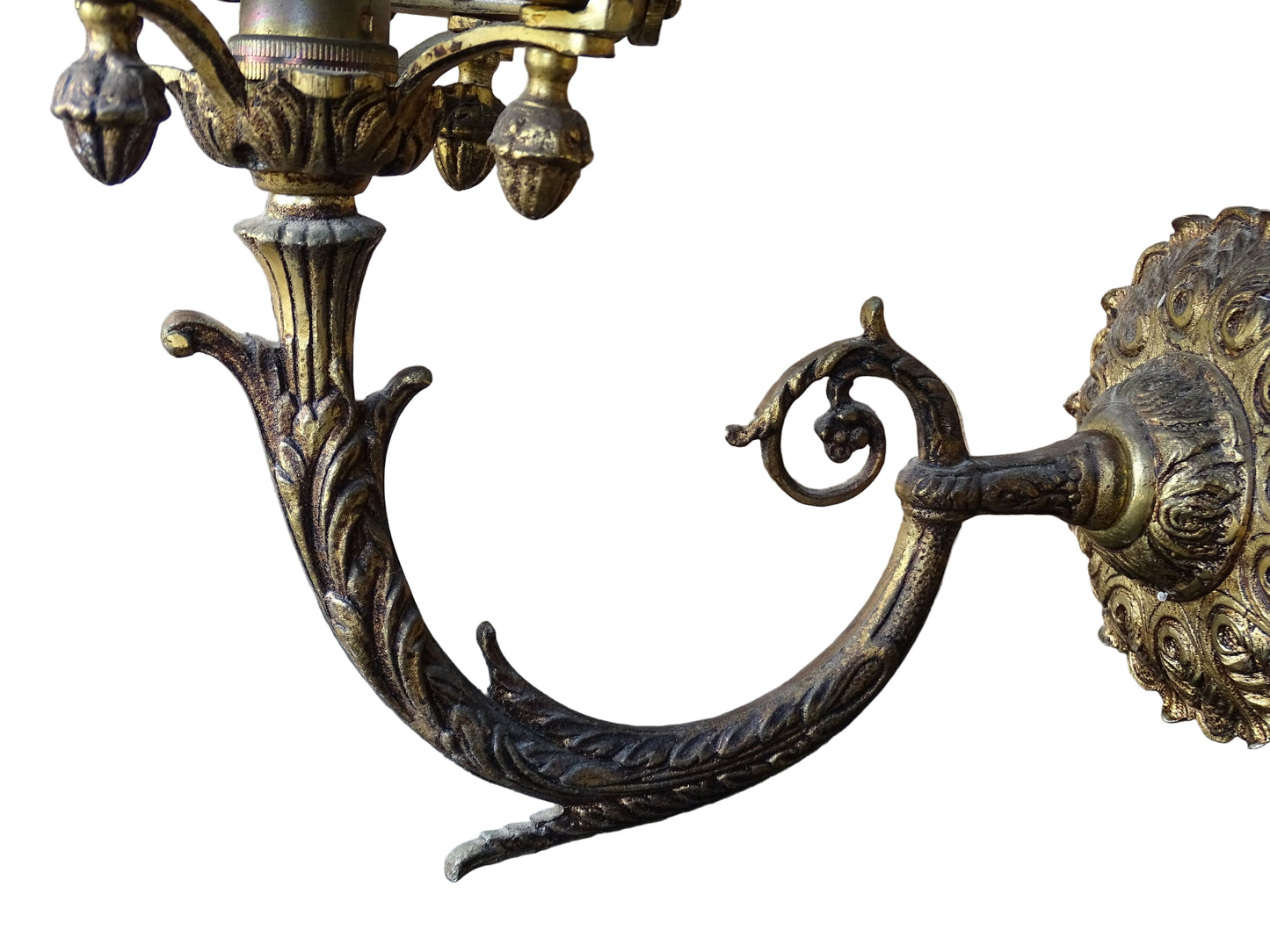 A beautiful French vintage wall light made from gilded metal with a clear cut-glass lantern. The frame has small finials to the top, leaf motifs around the sides, and an ornate scrolling arm. The glass has a diamond pattern.