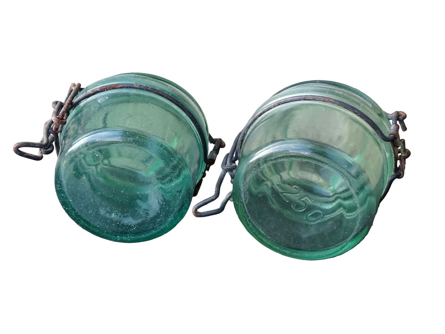 Pair of French vintage green glass preserving jars by L'Ideale. They have thick glass, embossed with the maker's name on top and original metal fasteners with a naturally aged finish. 