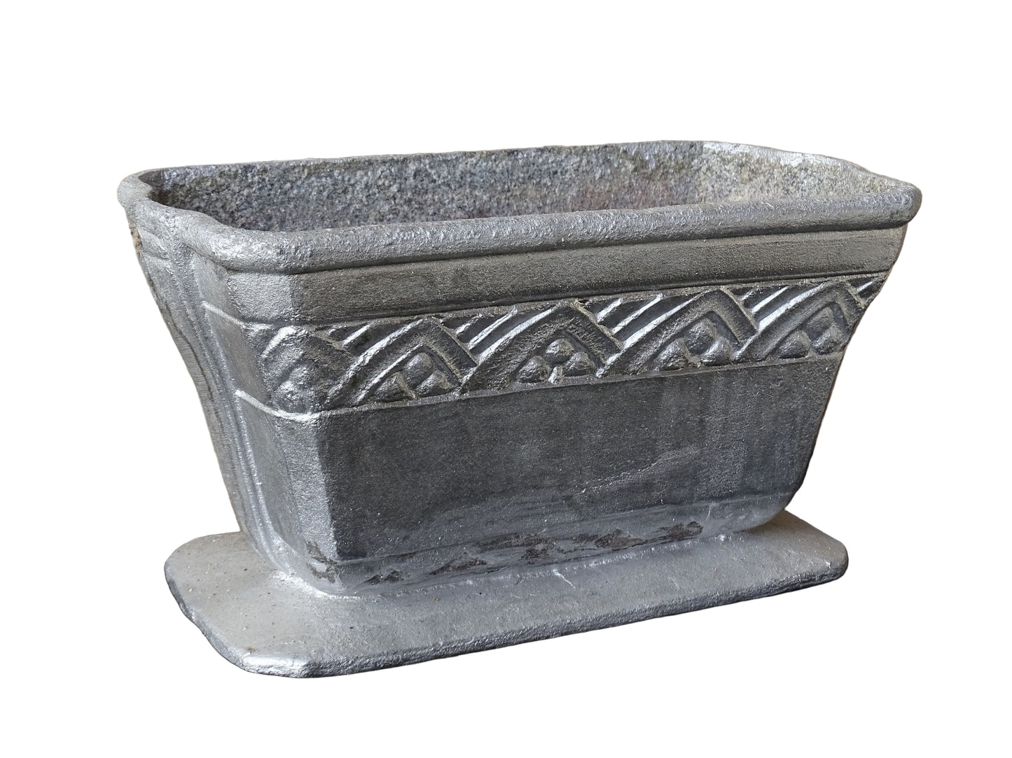 French vintage cast iron planter in silver with a rectangular, flared shape that widens towards the top. It sits on an pedestal-style base. It has a raised geometric border around the upper edge.