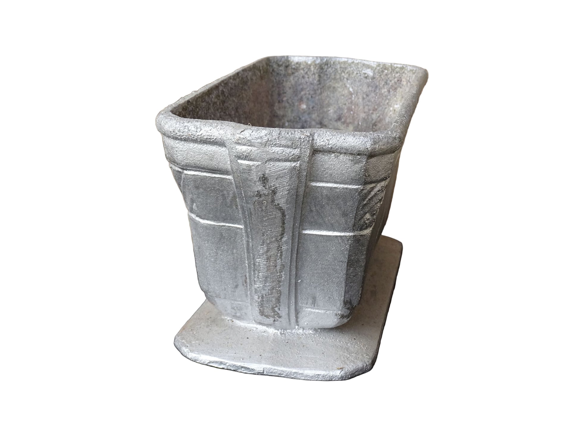 French vintage cast iron planter in silver with a rectangular, flared shape that widens towards the top. It sits on an pedestal-style base. It has a raised geometric border around the upper edge.