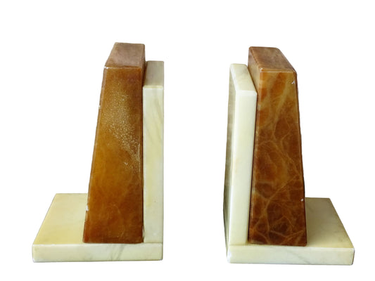 Pair of vintage alabaster bookends with a sculptural look. They have geometric lines with an Art Deco influence. Each bookend has a soft cream alabaster with a warm caramel toned section.