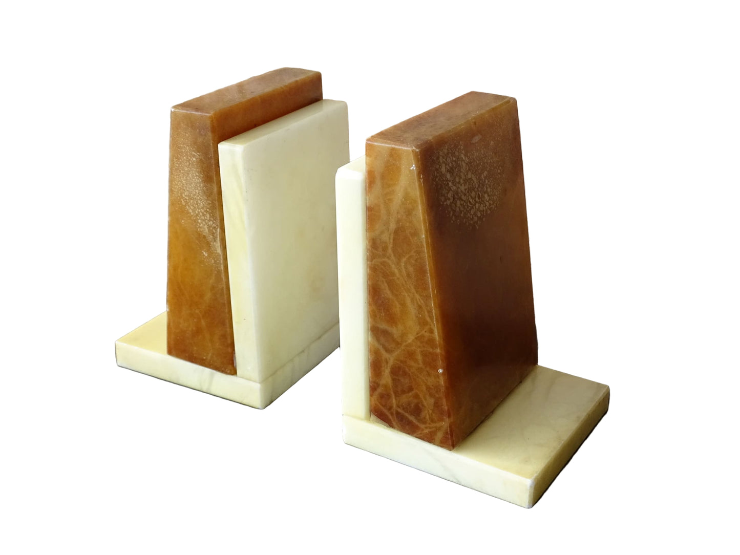 Pair of vintage alabaster bookends with a sculptural look. They have geometric lines with an Art Deco influence. Each bookend has a soft cream alabaster with a warm caramel toned section.