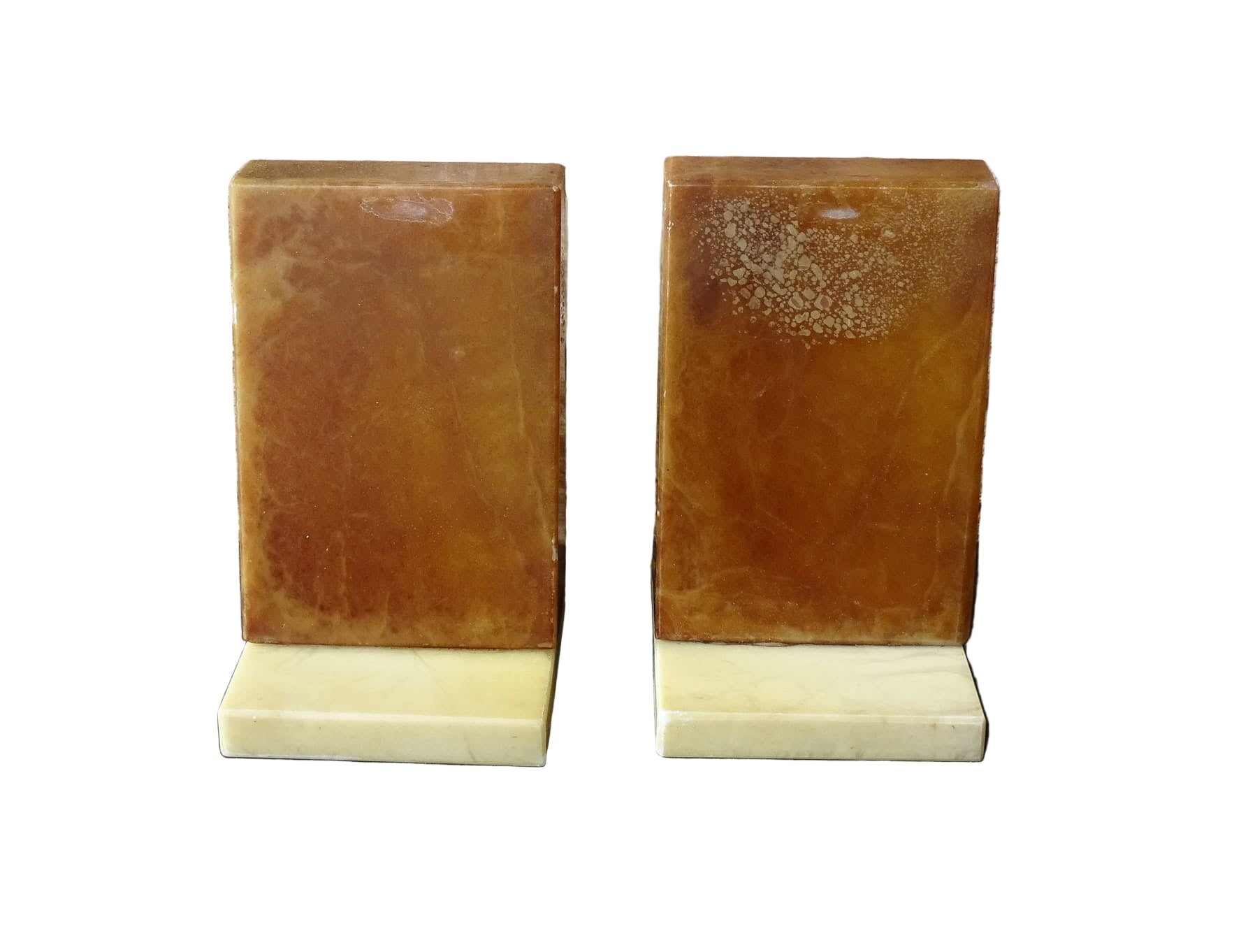 Pair of vintage alabaster bookends with a sculptural look. They have geometric lines with an Art Deco influence. Each bookend has a soft cream alabaster with a warm caramel toned section.