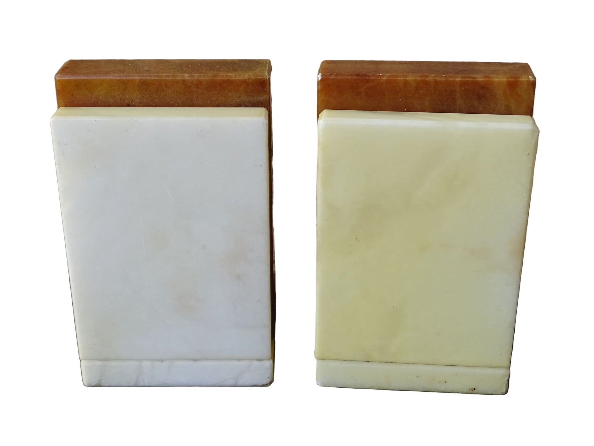Pair of vintage alabaster bookends with a sculptural look. They have geometric lines with an Art Deco influence. Each bookend has a soft cream alabaster with a warm caramel toned section.