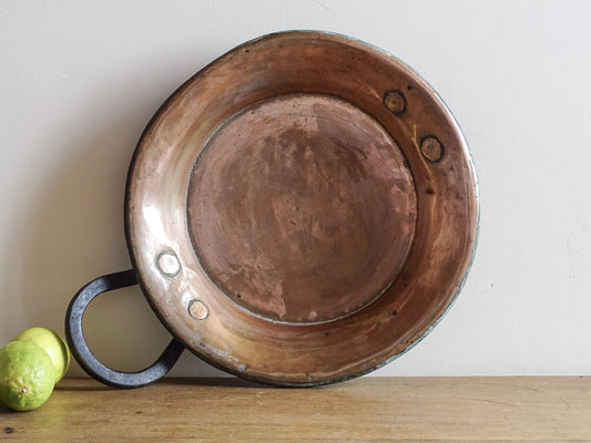 French antique copper pan with a wrought iron handle. 