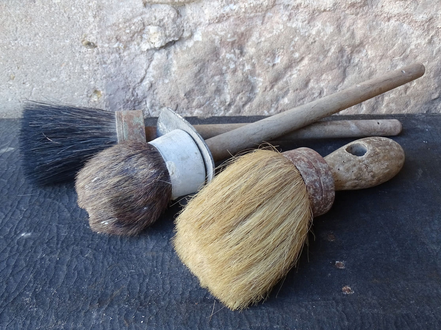 Three old French vintage paint brushes with wooden handles and horse hair brushes.