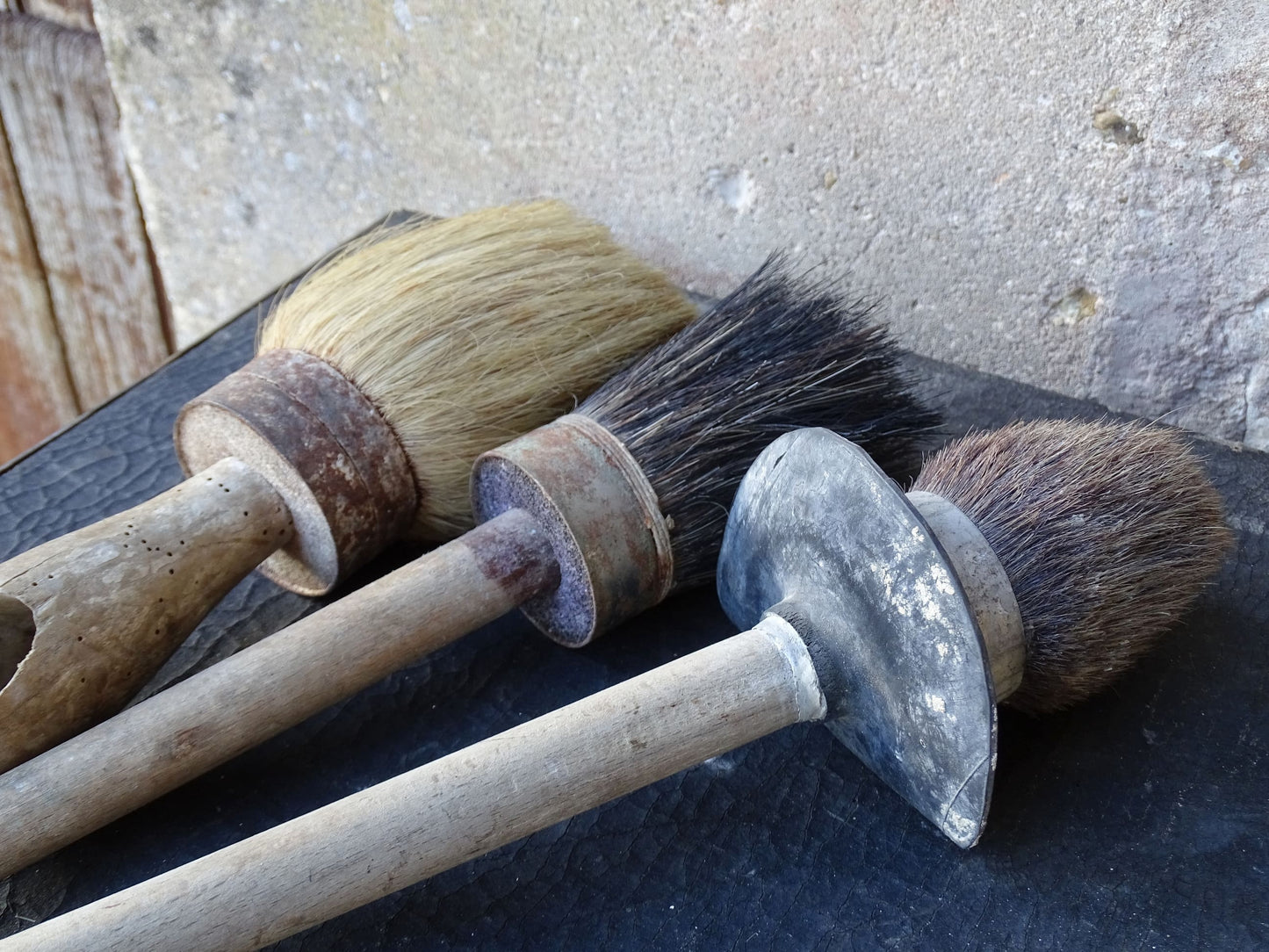 Three old French vintage paint brushes with wooden handles and horse hair brushes.