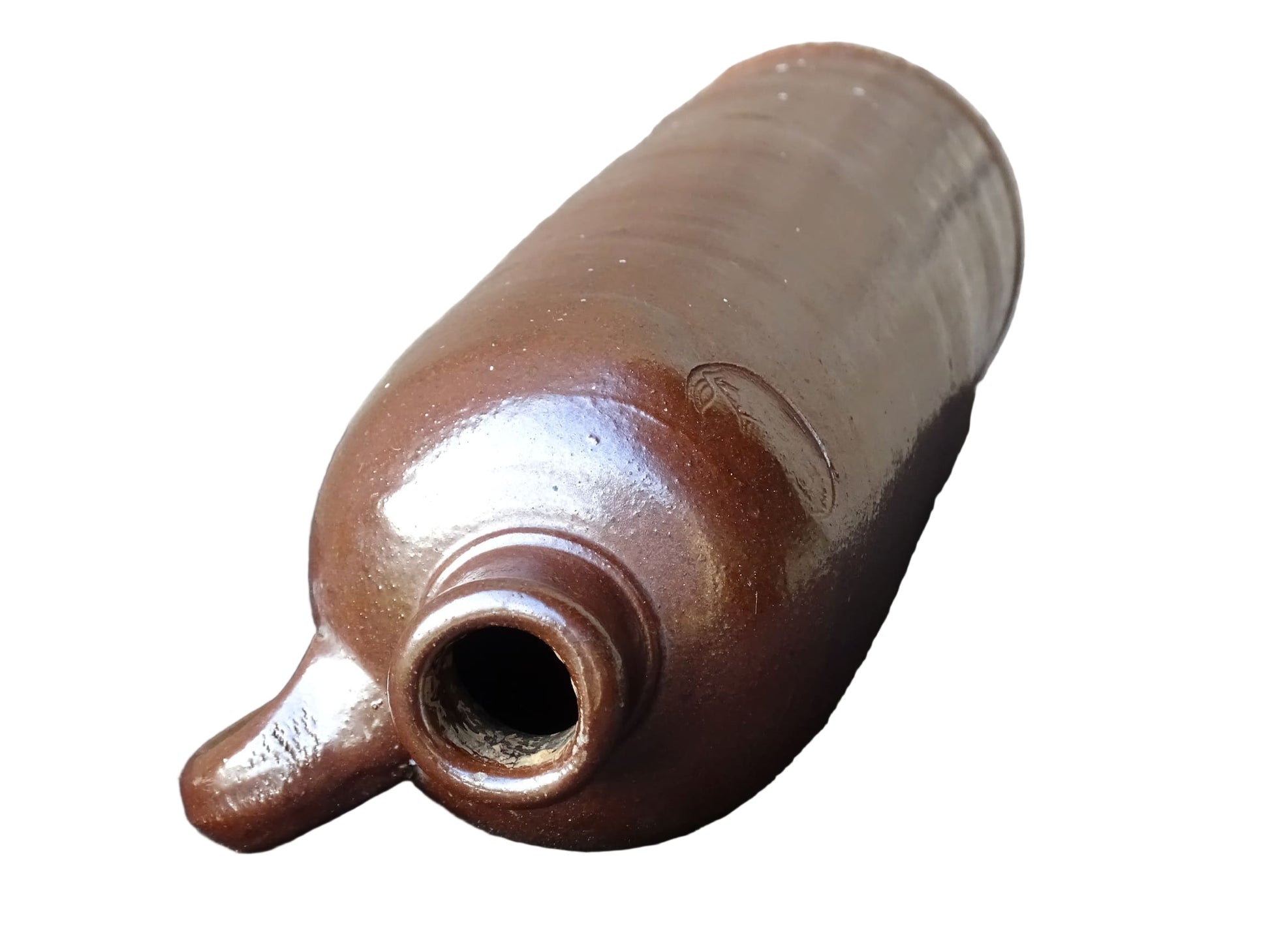 Antique salt glazed stoneware bottle, with a raised lion medallion on the shoulder and a loop handle. Bottle with textured surface and deep brown glaze. 