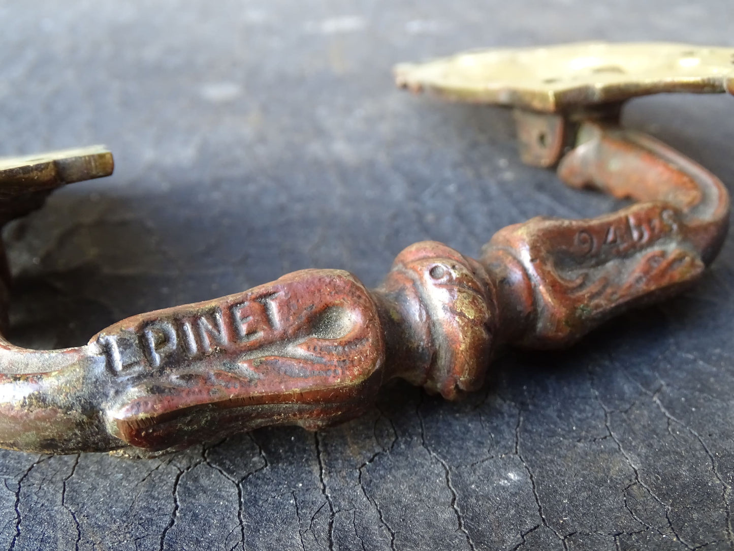 Pair of French antique gilt bronze drawer pulls with ribbon detailing, signed L.Pinet. Nineteenth century ormolu handles. 