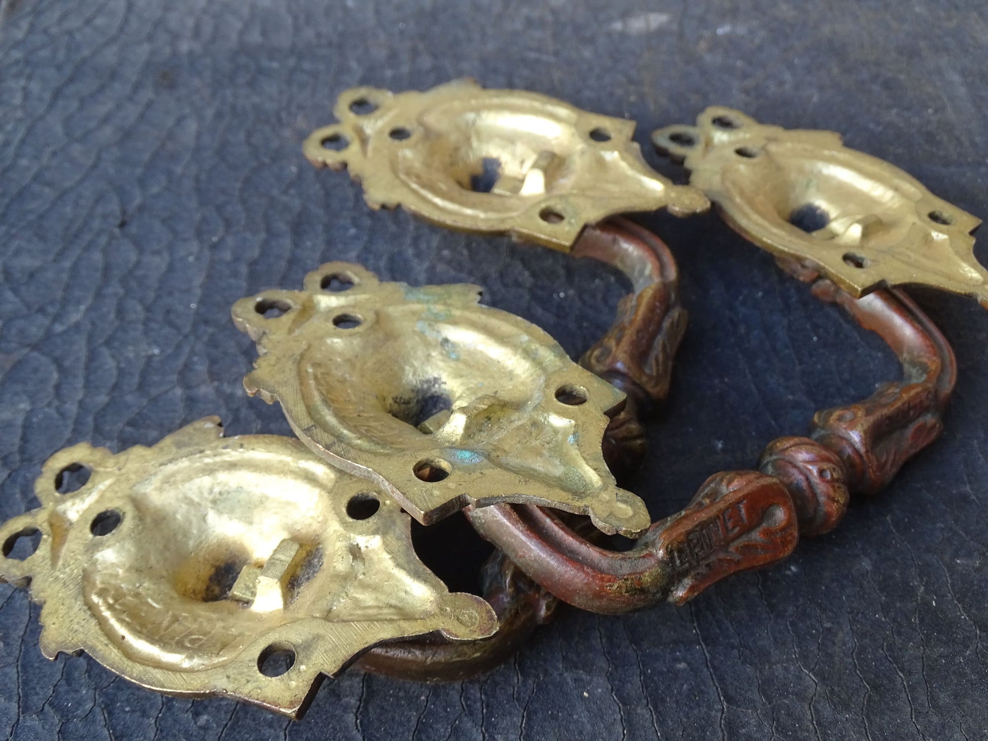 Pair of French antique gilt bronze drawer pulls with ribbon detailing, signed L.Pinet. Nineteenth century ormolu handles. 
