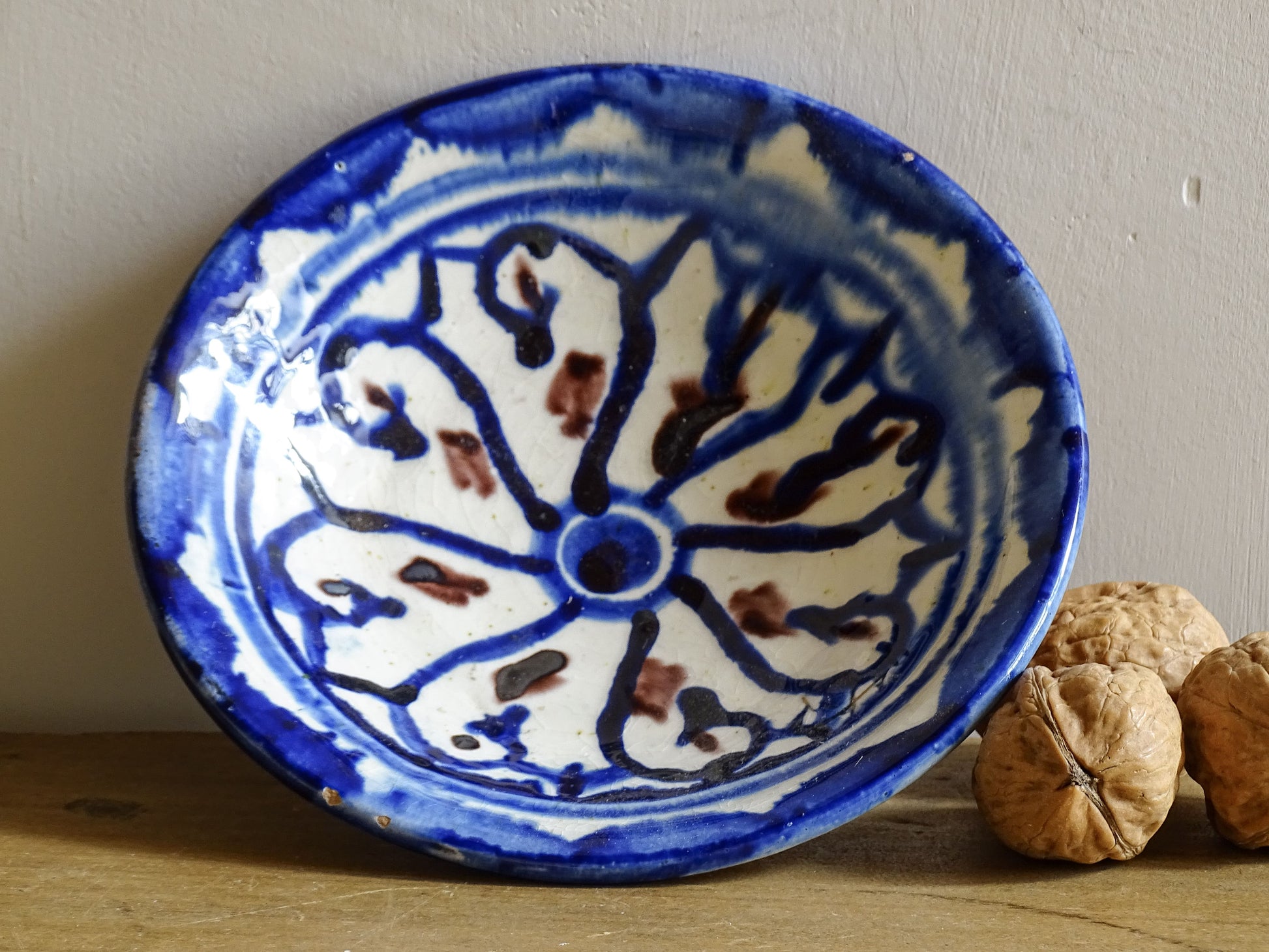 Vintage Moroccan ceramic dish with a blue glaze pattern, trinket dish