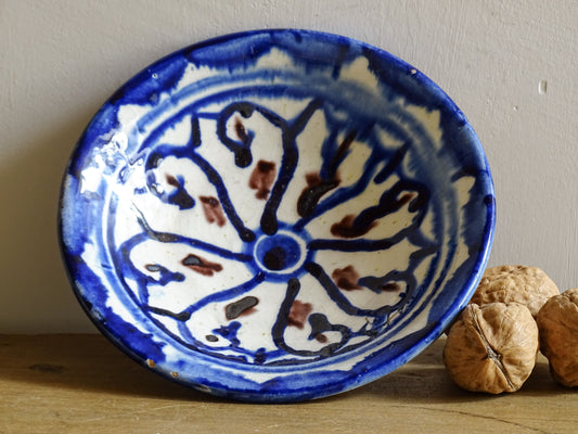 Vintage Moroccan ceramic dish with a blue glaze pattern, trinket dish