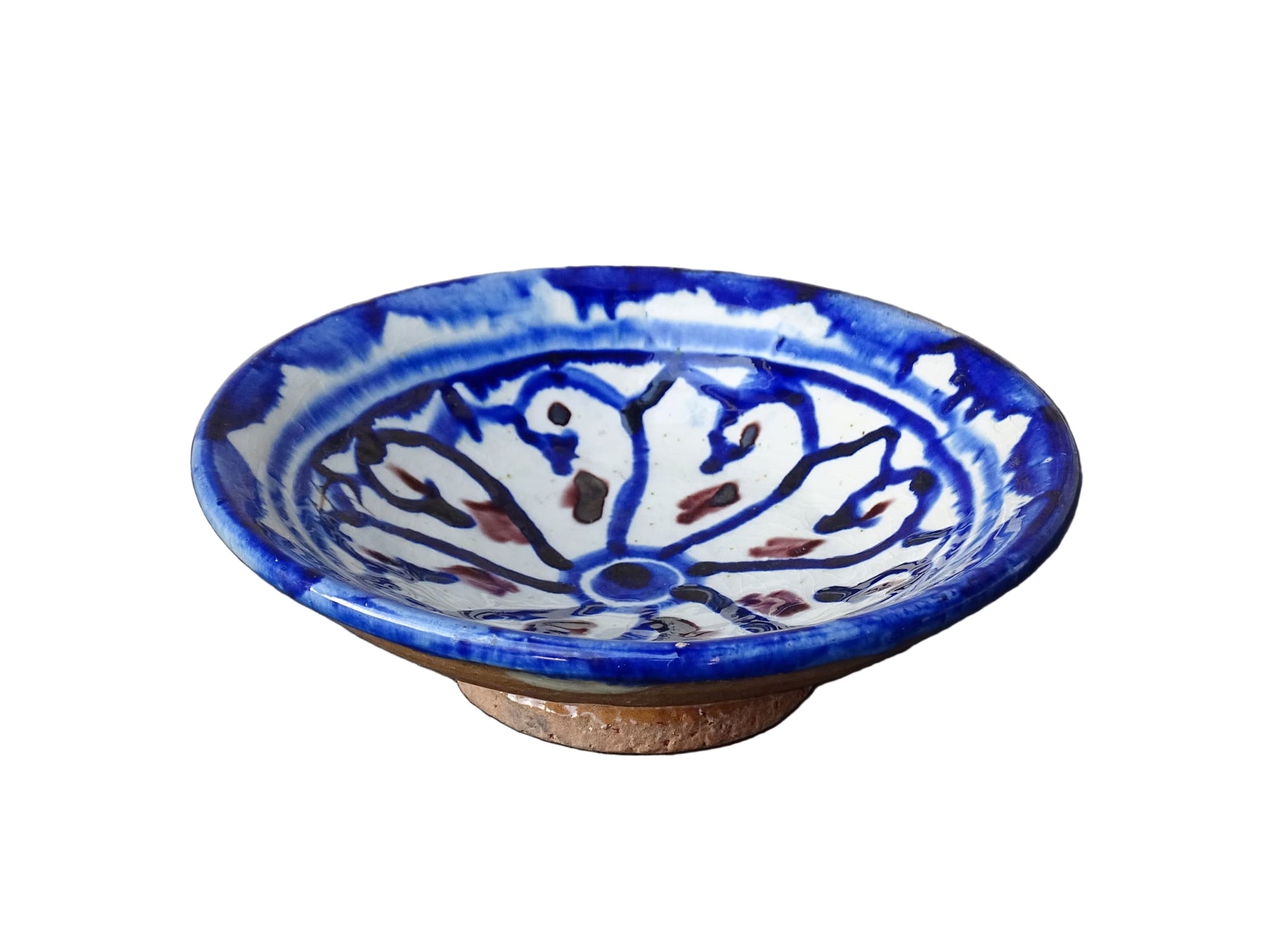 Small vintage ceramic dish with a blue glaze pattern with flecks of red. Moroccan earthenware dish with a hand-painted design.