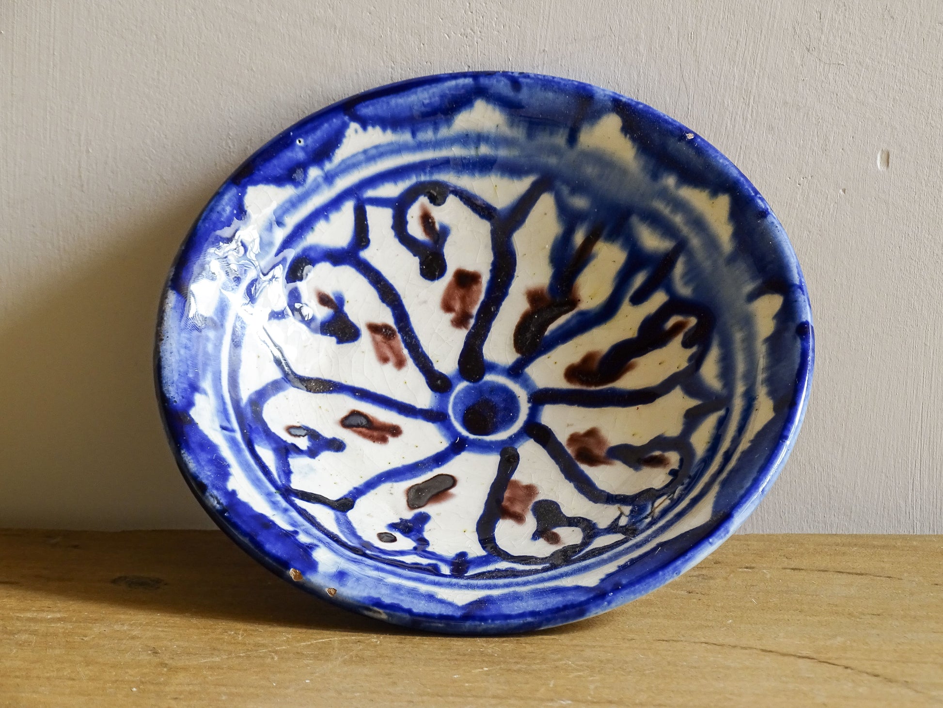 Vintage Moroccan ceramic dish with a blue glaze pattern, trinket dish