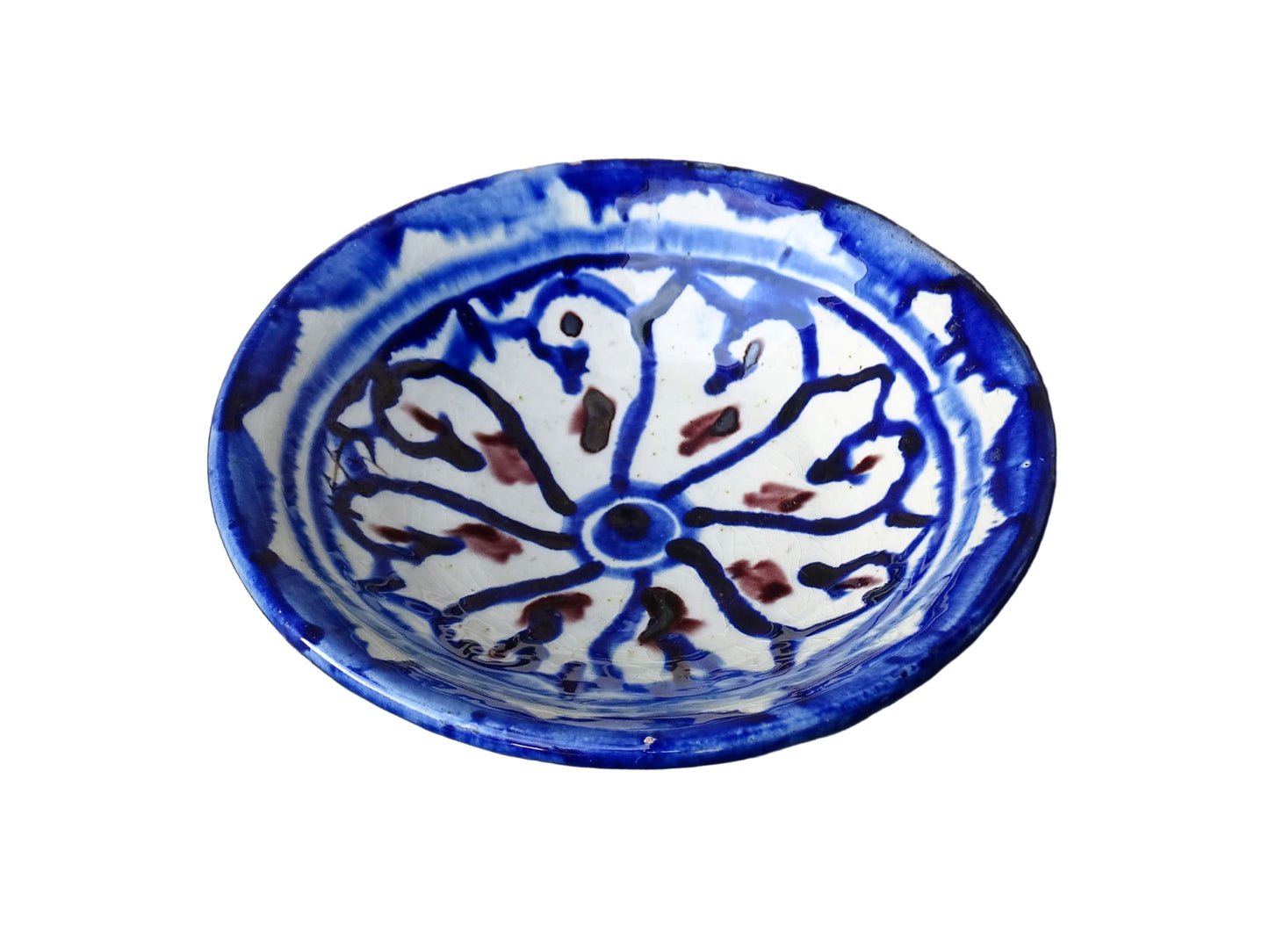 Small vintage ceramic dish with a blue glaze pattern with flecks of red. Moroccan earthenware dish with a hand-painted design.